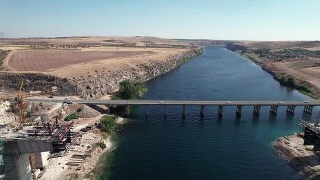 Aerial view of bridge over Euphrates river under construction. Highway bridge and bridge being constructed aerial view. Sanliurfa province, Turkey