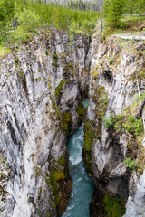 Fototapeta na wymiar Teal water flowing through Marble Canyon in Kootenay National Park Canada
