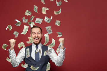 Successful excited businessman enjoying wealth with hundred dollar banknotes flying in the air on...