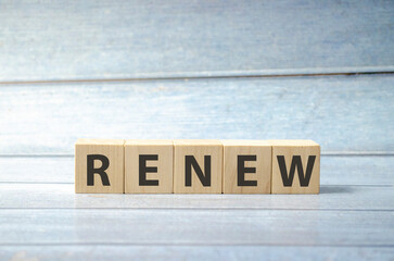 word renew on wooden blocks and blue background