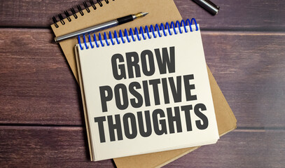 Grow positive thoughts symbol. Concept words Grow positive thoughts on notepad
