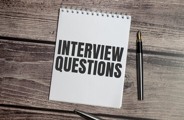 interview questions words on notepad and office supplies