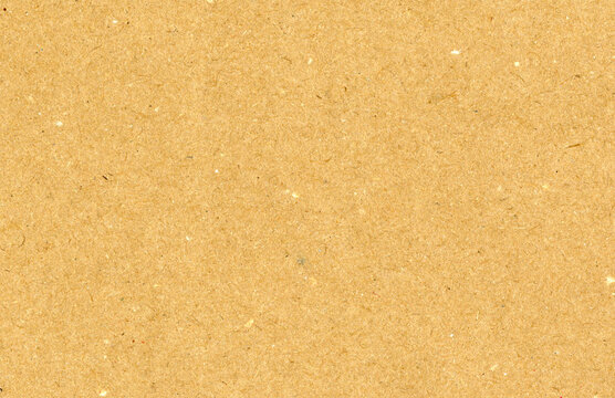 Highly detailed close up brown cardboard recycled uncoated smooth paper texture scan with dust and colorful particles with copyspace for text for high resolution wallpaper or mockup