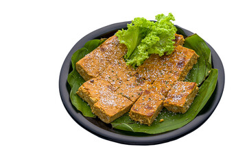 House-made Nyonya Otah Slices served in a dish isolated on white background side view