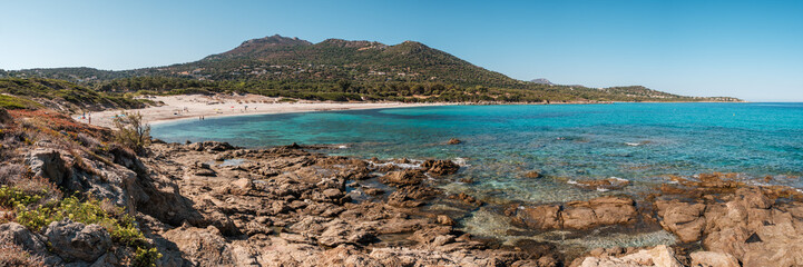 Panoramic view of the clear turquoise Mediterranean sea and rocky coastline at Bodri beach in the Balagne region of Corsica