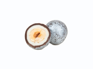 Silver hazelnut candy in chocolate with cut half isolated on white background