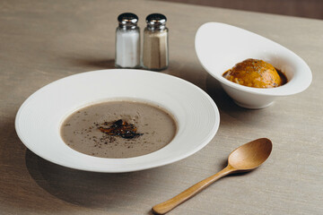 Tea Time Special Truffle Cashew Mushroom Soup with fried ball and salt served in a dish isolated on dark background side view