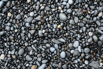 Icelandic black sand. Background, pattern, volcanic black sea sand.