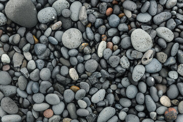 Icelandic beach, sand and stones texture. Gray and black pebble background