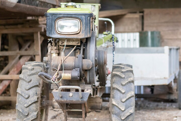 Typical heavy diesel walking tractor with trailer. Agricultural transport equipment of the...