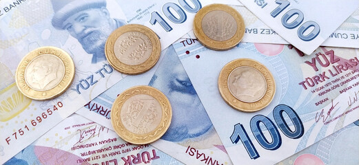 Close up view of one hundred Turkish lira banknotes with coins.