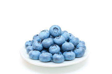 Fresh blueberries on a white saucer