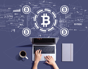 Bitcoin theme with person using a laptop computer