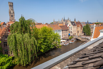 Naklejka premium Bruges belfry tower, above flemish architecture buildings, Belgium
