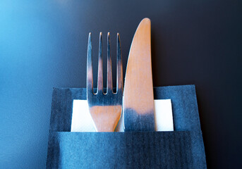 fork and knife in a paper bag with napkin