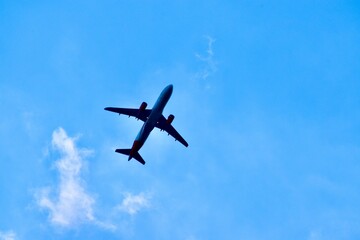 Fototapeta na wymiar Bottom view of an aeroplane in the sky