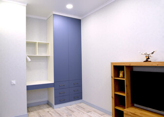 Wardrobe and work area in the interior of a living room