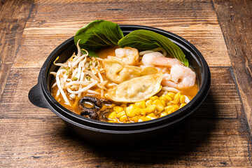 Sushi black plate on wood table,