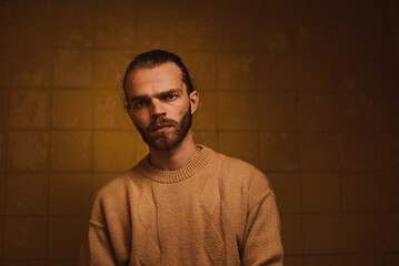 Brutal man in the bathroom in contrast light