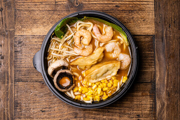  Sushi black plate on wood table, top view.