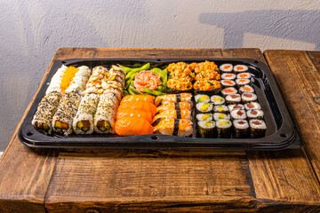 Sushi black plate on wood table,