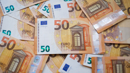 The background consists of many euro banknotes of different denominations. Finance and business concept