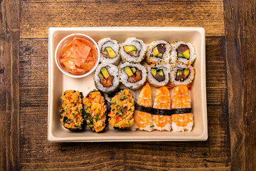 Sushi take away tray on wood table, top view 