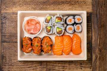 Sushi take away tray on wood table, top view 