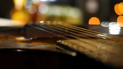 Acoustic guitar bridge and strings close up. Close-up of guitar strings. Elegant guitar