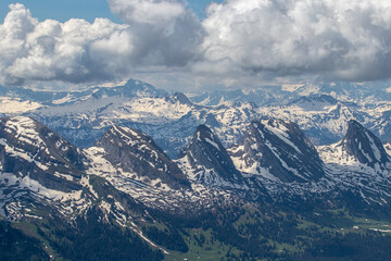 Fototapeta na wymiar Alpine peaks in the summer under the dramatic clouds