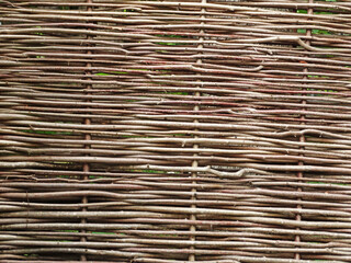 Fence wicker from the vine, texture, background. Wicker vine fence. woven vines texture embossed background. Organic woven willow wicker fence