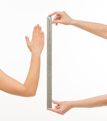 hands with a ruler measure something on a white background isolated.