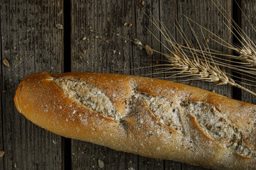 Fresh bread baguette loaf with seeds in a rustic style. Baking homemade healthy bread