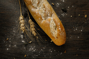 Fresh bread baguette loaf with seeds in a rustic style. Baking homemade healthy bread