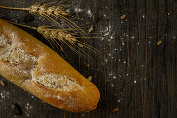 Fresh bread baguette loaf with seeds in a rustic style. Baking homemade healthy bread