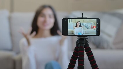 Mobile screen view of arab hispanic female blogger influencer woman girl record digital video on camera phone at home online broadcasting educational tutorial blog live vlog for popular social network
