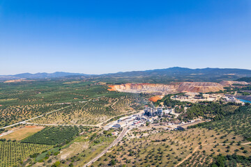 Drone shot during a beautiful day with clear blue sky of an open-mine in Greece. Human and nature concept. High quality photo