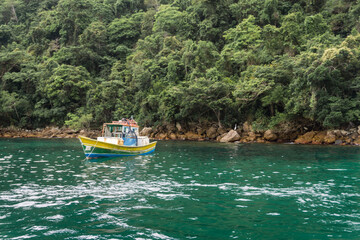 Naklejka na ściany i meble Boat at the coast of Ilha Grande, Angra dos Reis town, State of Rio de Janeiro, Brazil. Taken with Sony ILCE 6000 16-5 lens, at 28mm, 1/60 f 5.6 ISO 100. Date: Dec 30, 2021