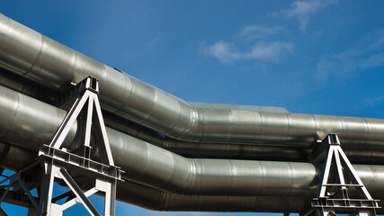 Naklejka premium pipeline, in the photo pipeline close-up against a background of green forest and blue sky.