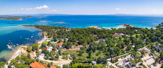 Drone aerial view of a small village next to the Karydi Beach. Summer holidays destination. Halkidiki Peninsula in Greece. High quality photo