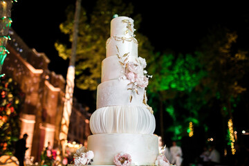 Multilevel wedding cake decorated with pink flowers