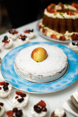 Pie on a blue plate with a pear in the middle