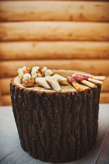 Rows of appetizers and starters on a wooden stump