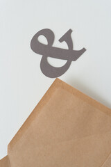 paper ampersand and envelope flap (pointing upwards)