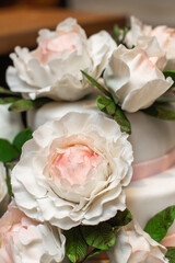 Multilevel wedding cake on the table decorated with roses