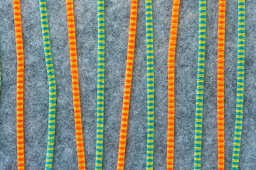 orange and green pipe cleaners on felt