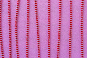 striped pipe cleaners on pink felt