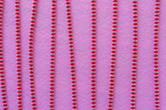 striped pipe cleaners on pink felt