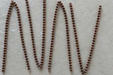 folded striped pipe cleaners on plain brown paper