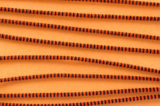 decorative background with pipe cleaners and orange felt
